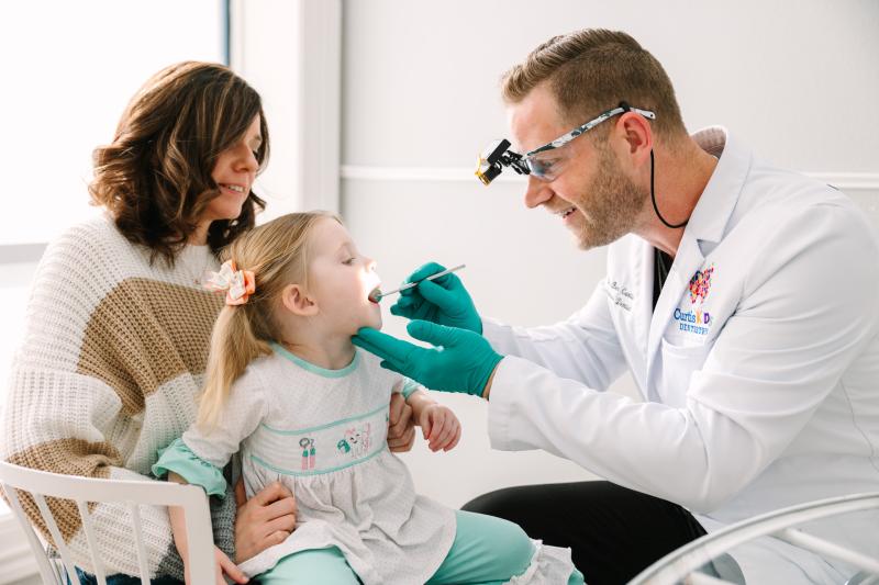 Pediatric dentist places white crowns on toddler teeth in Canton, TX.