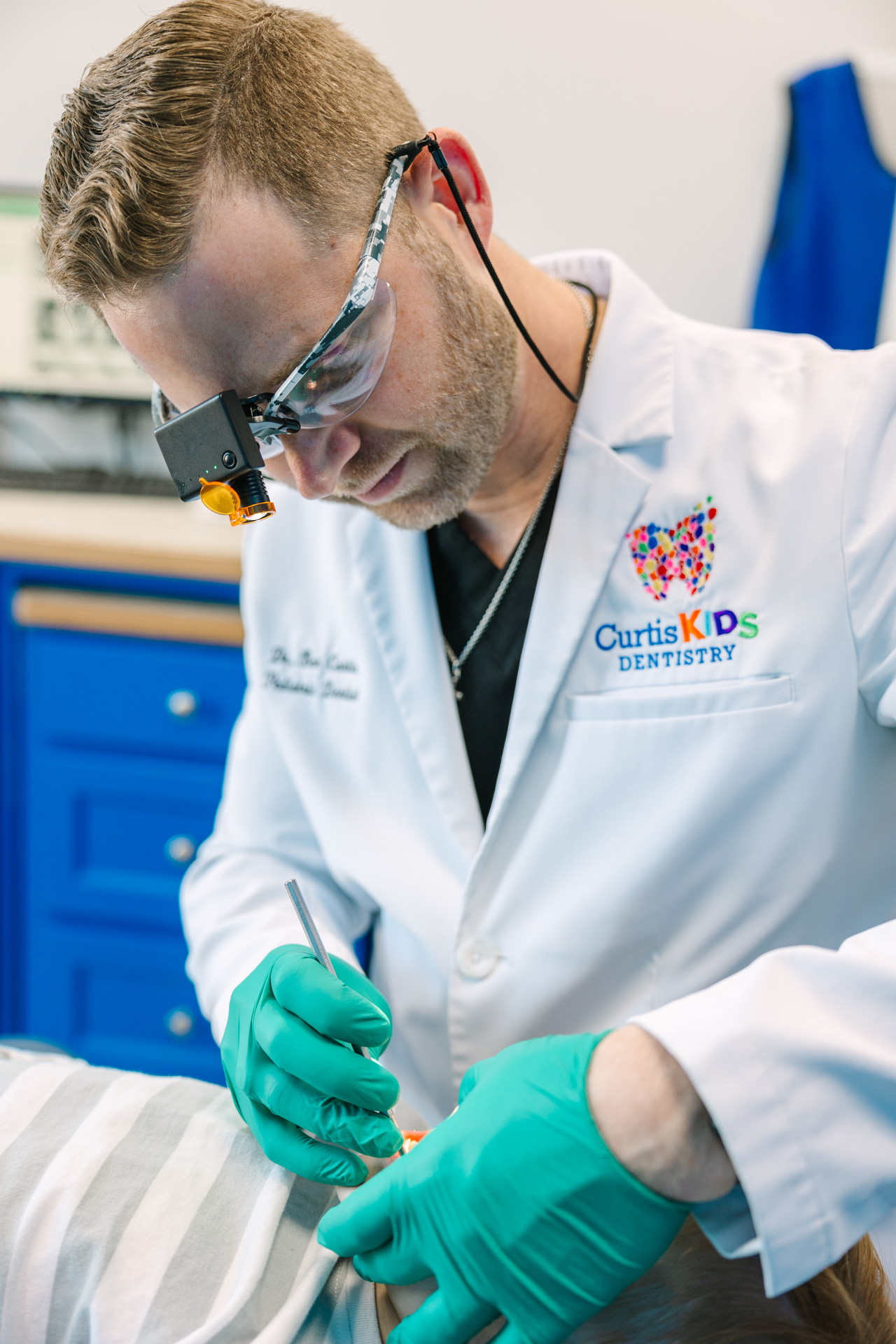 Dr. Curtis and Dental Assistant working on a patient's teeth