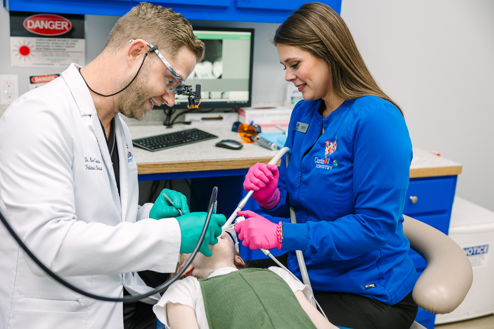Dr. Curtis and Dental Assistant working on a patient's teeth