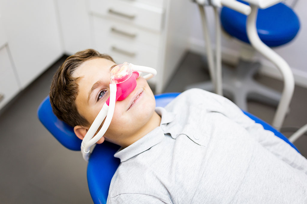 Child with nitrous oxide hose over his nose